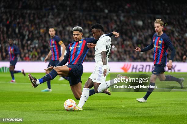 Vinicius Junior of Real Madrid shoots whilst Ronald Araujo of FC Barcelona attempts to block the ball during the Copa Del Rey Semi Final Leg One...