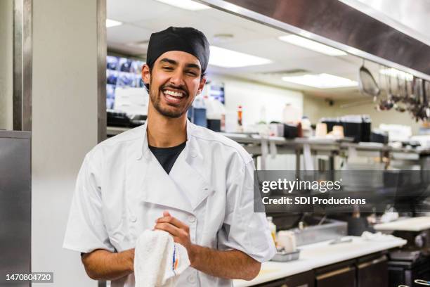 male chef smiles proudly while having his photo taken - master leader cooking stock pictures, royalty-free photos & images