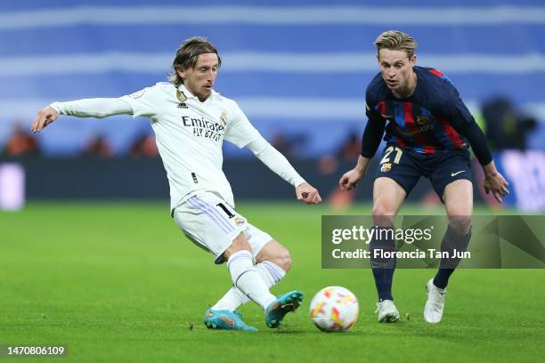Luka Modric of Real Madrid and Frenkie de Jong of FC Barcelona battle for the ball during the Copa Del Rey Semi Final Leg One match between Real...
