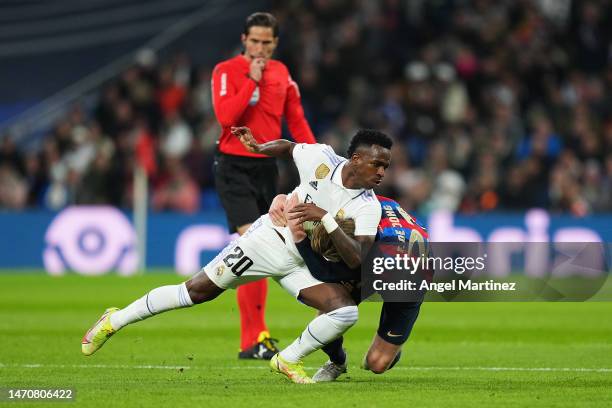 Vinicius Junior of Real Madrid and Frenkie de Jong of FC Barcelona clash during the Copa Del Rey Semi Final Leg One match between Real Madrid CF and...