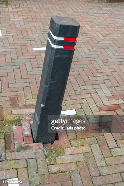 a traffic bollard which is skewed in the street - bollards stock pictures, royalty-free photos & images