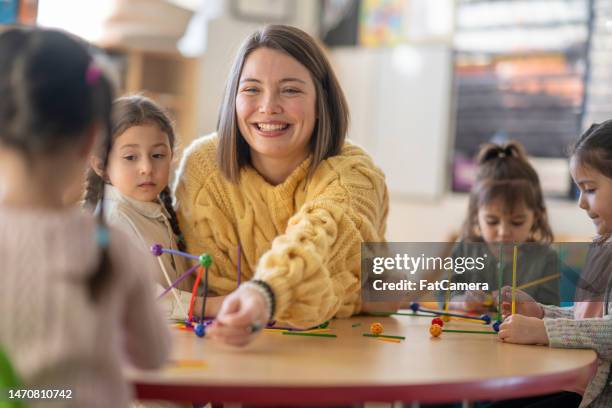 kindergarten students with their teacher - childcare stock pictures, royalty-free photos & images