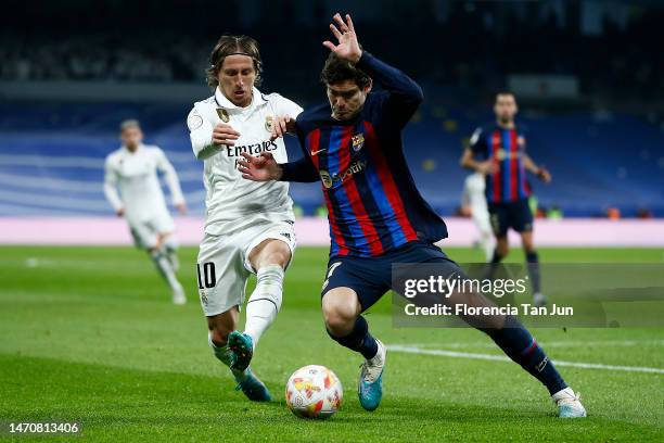 Luka Modric of Real Madrid and Marcos Alonso of FC Barcelona battle for the ball during the Copa Del Rey Semi Final Leg One match between Real Madrid...