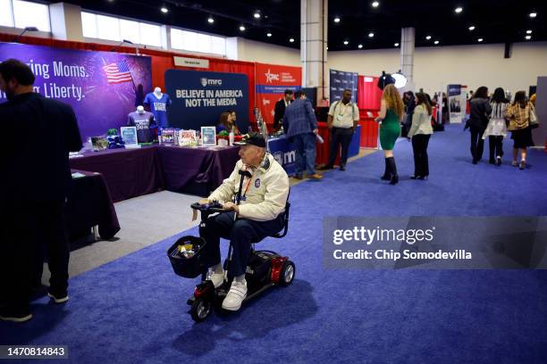 Attendees visit booths promoting political organizations along side products like perfume and cigars in the expo hall of the Conservative Political...