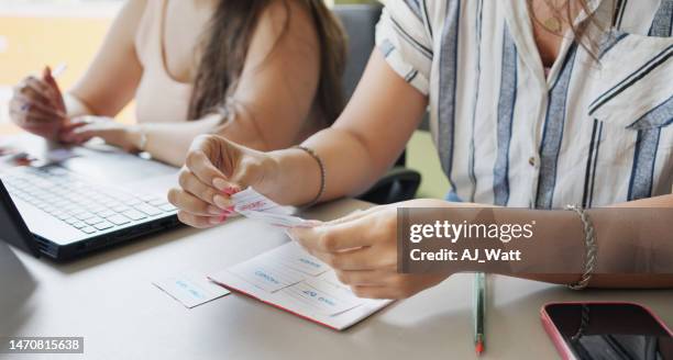 female adult students reading a flash card during classroom language activity - games workshop stock pictures, royalty-free photos & images