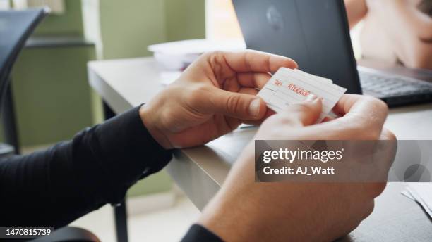 male adult student reading a flash card during classroom language activity - flash card stock pictures, royalty-free photos & images