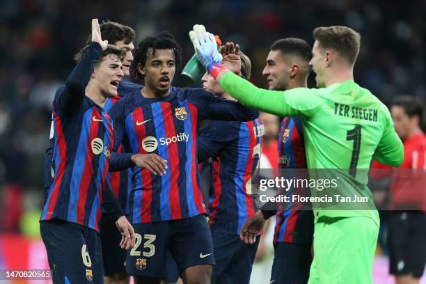 Gavi, Jules Kounde and Marc-Andre ter Stegen of FC Barcelona celebrate following the Copa Del Rey Semi Final Leg One match between Real Madrid CF and...