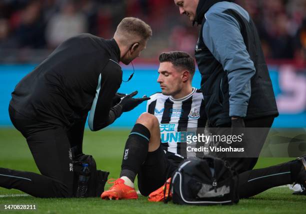 Fabian Schar of Newcastle United receives treatment for a head injury during the Carabao Cup Final match between Manchester United and Newcastle...