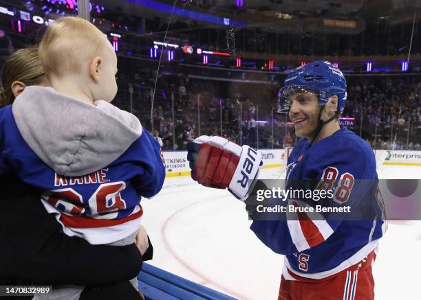 Patrick Kane of the New York Rangers skates in warm-ups prior to the game against the Ottawa Senators and greets his son at Madison Square Garden on...