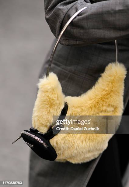 Guest is seen wearing a yellow faux fur bag and Prada mini bag outside the Chloe show during Paris Fashion Week F/W 2023 on March 02, 2023 in Paris,...