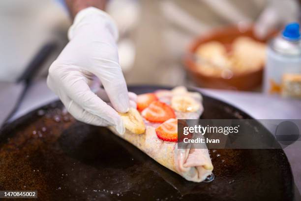 cooking a french crepe, pancake in a pan with mixed berry and cream - maslenitsa stock pictures, royalty-free photos & images