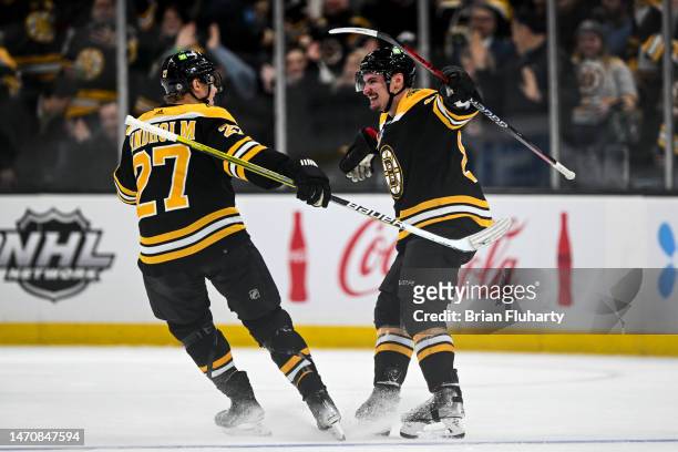 Dmitry Orlov of the Boston Bruins celebrates with Hampus Lindholm after scoring a goal against the Buffalo Sabres during the second period at the TD...
