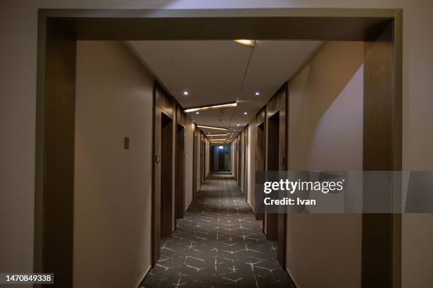 long and dark hotel corridor. indoor architectural feature. - hotel hallway stock pictures, royalty-free photos & images