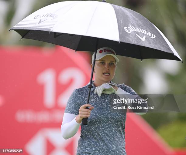Nanna Koerstz Madsen of Denmark holds an umbrella as he walks off the twelfth tee during Day Two of the HSBC Women's World Championship at Sentosa...