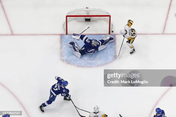 Goalie Andrei Vasilevskiy of the Tampa Bay Lightning stretches to make a save against Jake Guentzel of the Pittsburgh Penguins during the first...