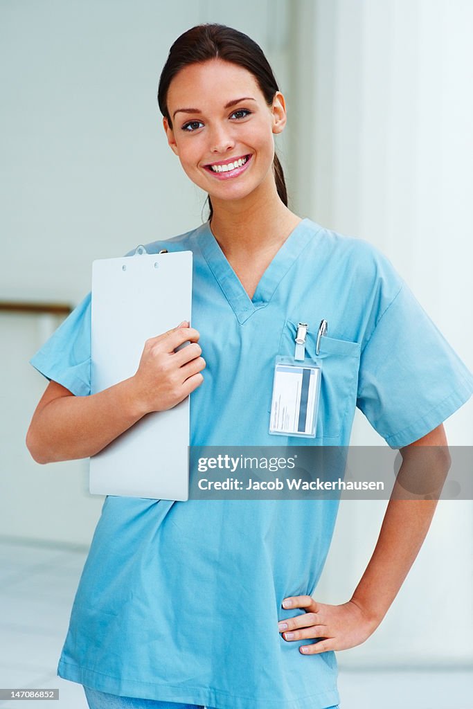 Close-up of a female doctor smiling and holding notepad