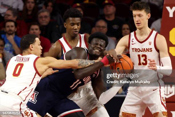 Oumar Ballo of the Arizona Wildcats drives to the basket against Kobe Johnson, Vincent Iwuchukwu and Drew Peterson of the USC Trojans during the...