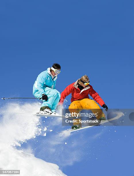 snowboarder gegen ski jumper - snowboard stock-fotos und bilder