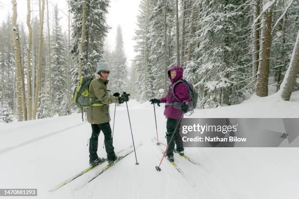 disrupt aging: senior adventures xc nordic skiing - purple jacket stock pictures, royalty-free photos & images