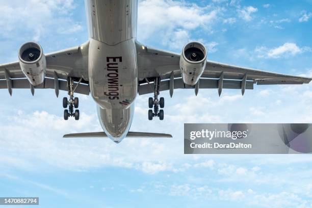 airplane landing on runway in pearson international airport at dusk, toronto,canada - a320 turbine engine stock pictures, royalty-free photos & images