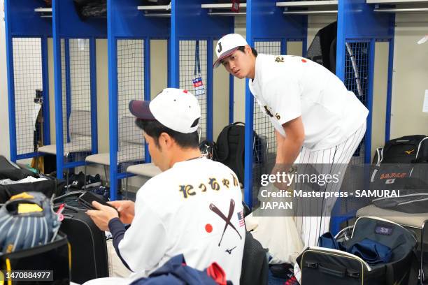 Pitcher Shohei Ohtani and Outfielder Kensuke Kondoh of Samurai Japan talk in the locker room prior to the practice game between Samura Japan and...