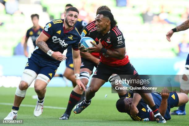 Sevu Reece of the Crusaders makes a break before scoring a try during the round two Super Rugby Pacific match between Crusaders and Highlanders at...