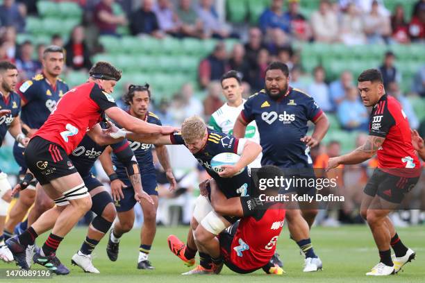 Sean Withy of the Highlanders is tackled during the round two Super Rugby Pacific match between Crusaders and Highlanders at AAMI Park, on March 03...