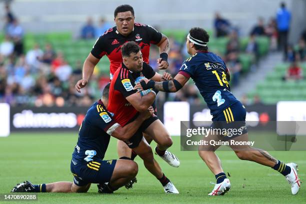 David Havili of the Crusaders is tackled during the round two Super Rugby Pacific match between Crusaders and Highlanders at AAMI Park, on March 03...