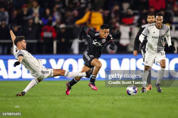 Andy Najar of DC United and Jonathan Osorio of Toronto FC compete for the ball during the second half of the MLS game at Audi Field on February 25,...