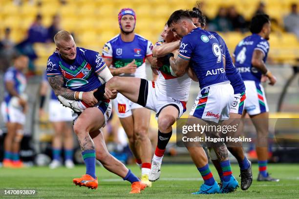 Lachlan Miller of the Knights is tackled during the round one NRL match between the New Zealand Warriors and Newcastle Knights at Sky Stadium on...