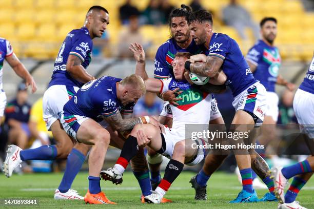 Lachlan Miller of the Knights is tackled during the round one NRL match between the New Zealand Warriors and Newcastle Knights at Sky Stadium on...