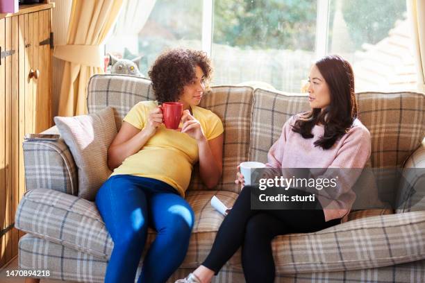 friends having a cuppa - asian woman at home stock pictures, royalty-free photos & images