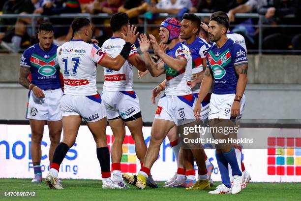 Hymel Hunt of the Knights celebrates after scoring a try with Kalyn Ponga and the team during the round one NRL match between the New Zealand...