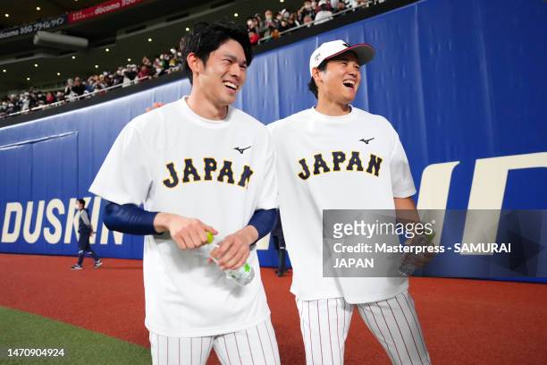 Pitcher Shohei Ohtani and Pitcher Roki Sasaki of Samurai Japan share a laugh prior to the practice game between Samura Japan and Chunichi Dragons at...