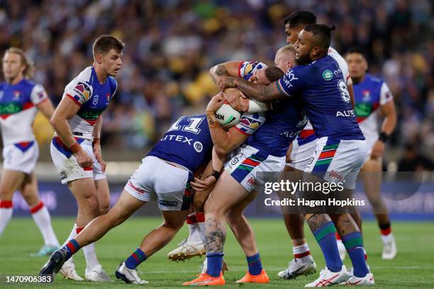 Adam Elliott of the Knights is tackled during the round one NRL match between the New Zealand Warriors and Newcastle Knights at Sky Stadium on March...