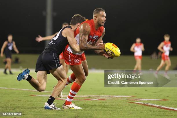 Lance Franklin of the Swans is tackled during the AFL Practice Match between the Sydney Swans and the Carlton Blues at Blacktown International...