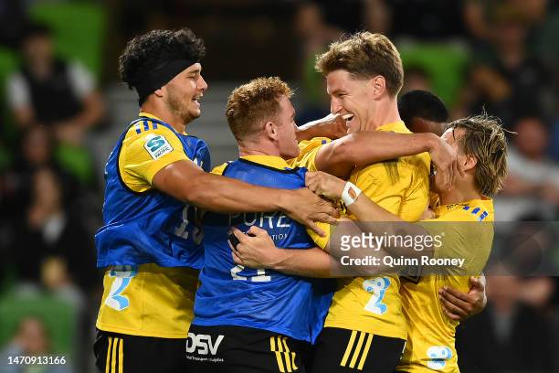 Joshua Moorby of the Hurricanes celebrates with team mates after scoring a try during the round two Super Rugby Pacific match between Melbourne...