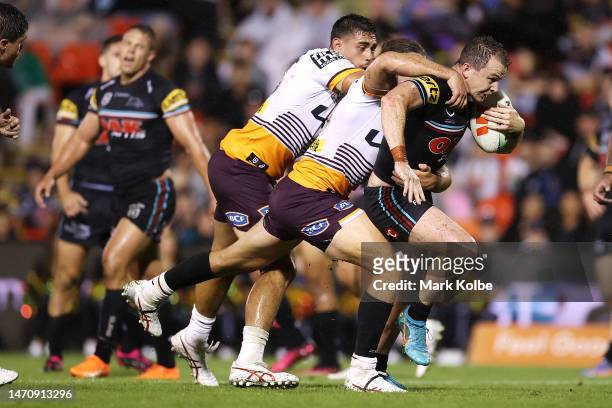 Dylan Edwards of the Panthers is tackled during the round NRL match between the Penrith Panthers and the Brisbane Broncos at BlueBet Stadium on March...