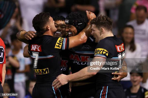 Stephen Crichton of the Panthers celebrates with his team mates after scoring a try during the round NRL match between the Penrith Panthers and the...