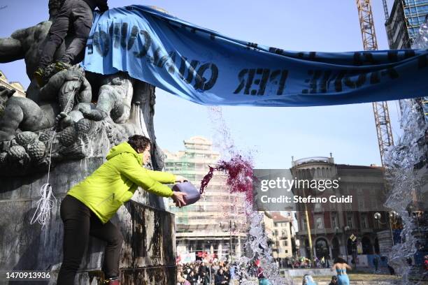 Protester throws red paint into a fountain during a climate strike on March 3, 2023 in Turin, Italy. Young climate activists are expected to walk out...