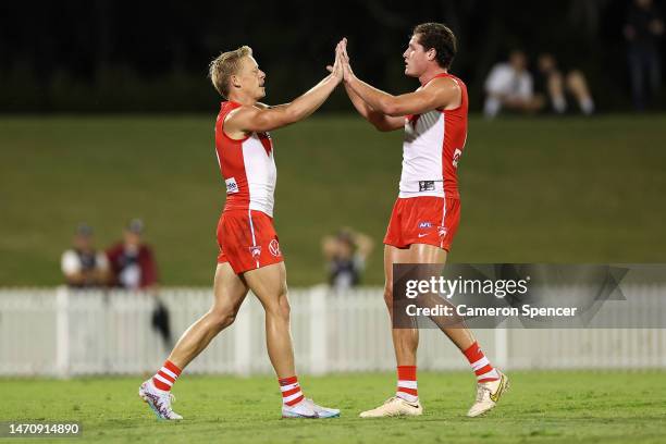 Isaac Heeney of the Swans celebrates kicking a goal with Hayden McLean of the Swans during the AFL Practice Match between the Sydney Swans and the...