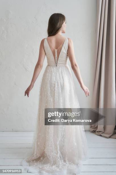 beautiful full length young woman in a retro dress with a neckline with lots of pearl buttons, unrecognisable person for book cover design or for an invitation wedding card with copy space. - lace dress stock pictures, royalty-free photos & images