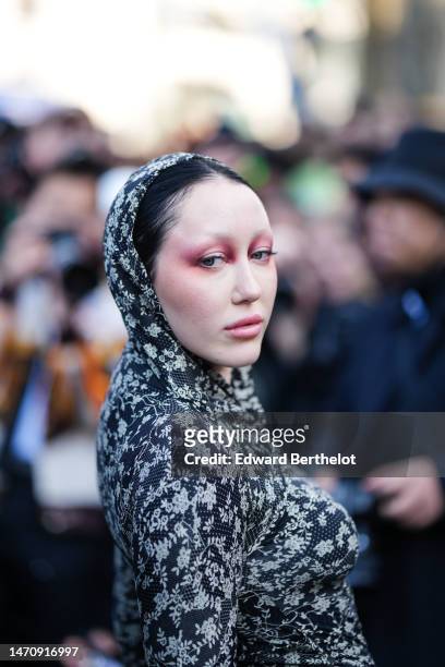 Guest wears a black and beige flower print pattern hoodie / long sleeves / wrap tube dress , outside Off-White, during Paris Fashion Week -...