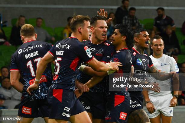 Lachie Anderson of the Rebels celebrates with team mates after scoring a try during the round two Super Rugby Pacific match between Melbourne Rebels...