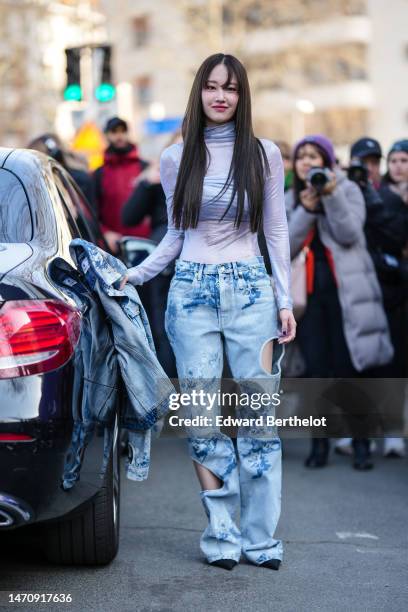 Guest wears a pale purple and silver tie and dye print pattern turtleneck / long sleeves top from Off-White , a dark and pale blue tie and dye print...