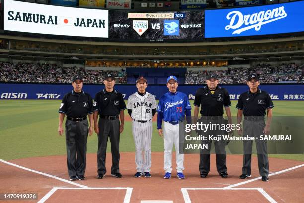 Head coach Hideki Kuriyama, Head coach Kazuyoshi Tatsunami of Chunichi Dragons pose with umpires prior to the practice game between Samura Japan and...