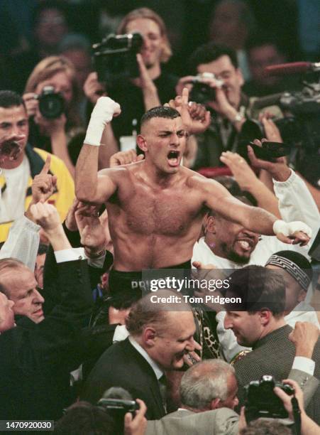 Prince Naseem Hamed from Great Britain raises his arms in celebration after defeating Cesar Soto from Mexico during their World Boxing Council and...