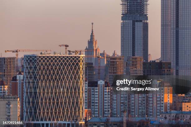 dominant constructing skyscrapers against urban skyline in aerial cityscape - russia skyline stock pictures, royalty-free photos & images