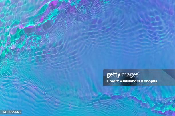 ethereal bright holographic blue, purple,  pink, turquoise, mint green transparent water surface texture with ripples, splashes, waves - nightclub bathroom stock pictures, royalty-free photos & images