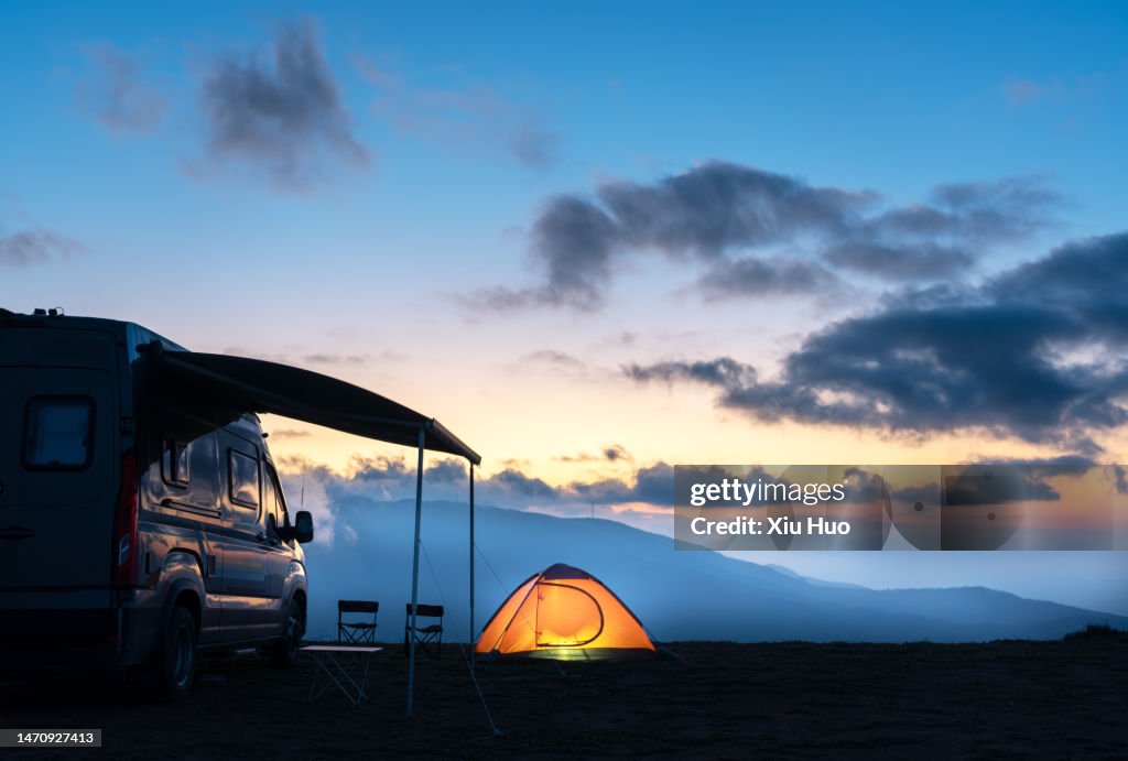 Motorhomes and tents in the camp at night
